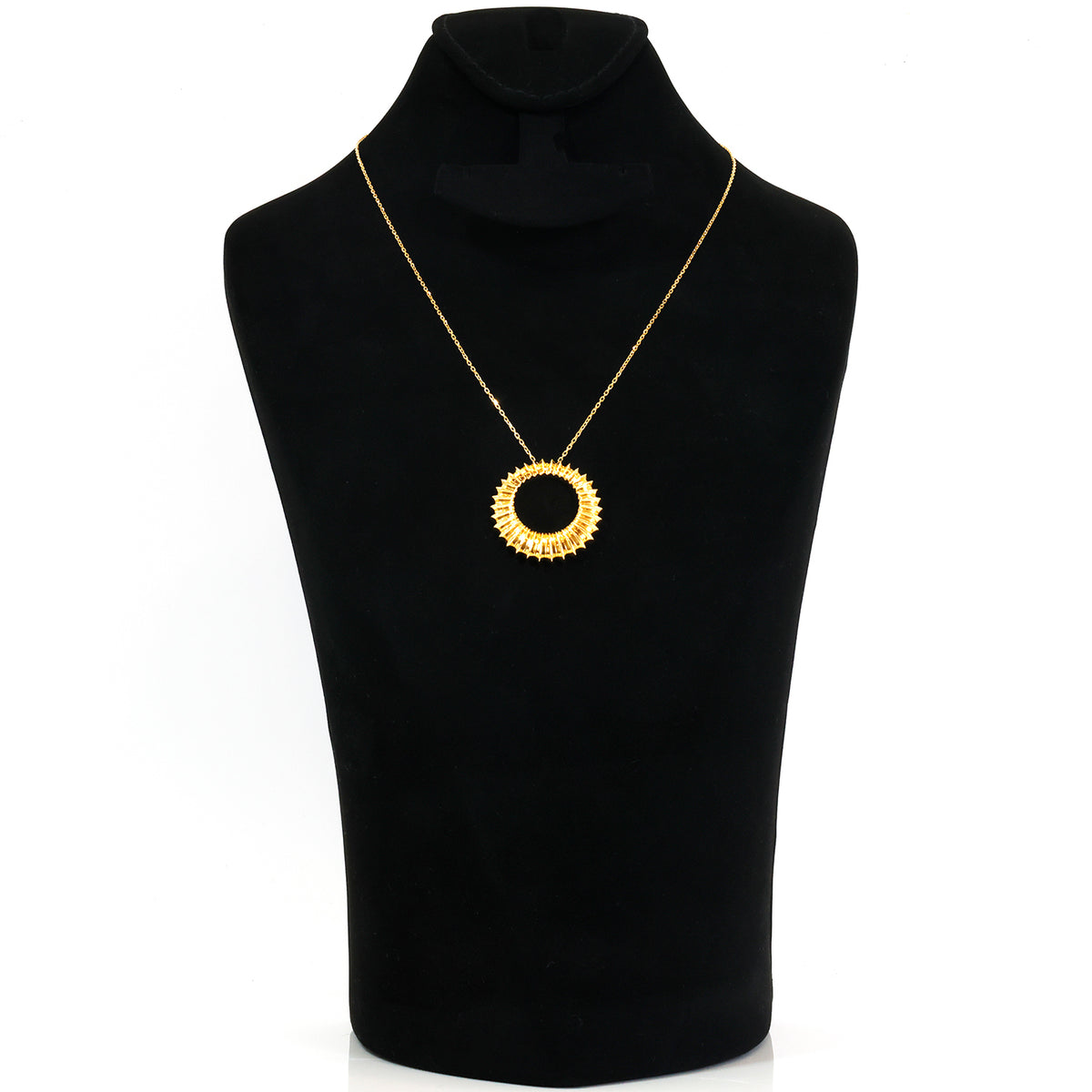 A gold circular pendant necklace with a scalloped edge, displayed on a black velvet jewelry bust against a white background.
