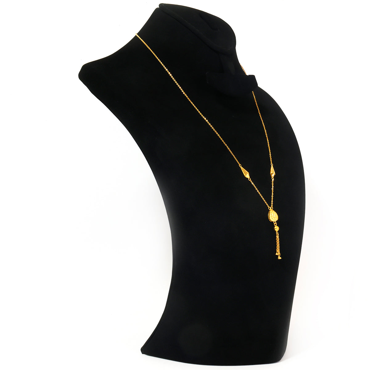 A gold-toned lariat-style necklace with a small oval pendant and dangling charm, displayed on a black jewelry bust against a white background.