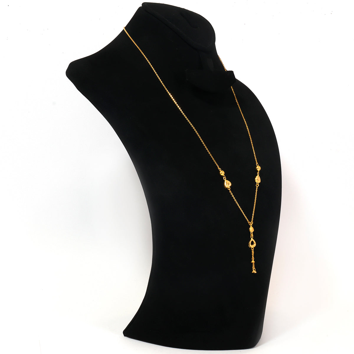 A gold chain necklace with small bead details and a teardrop pendant, displayed on a black jewelry bust against a white background.
