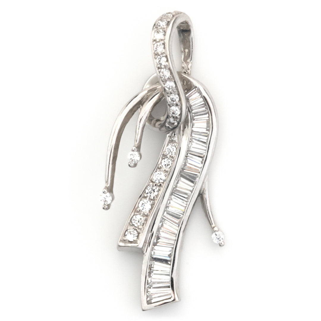 A silver-toned pendant featuring multiple flowing, ribbon-like curved elements set with clear baguette and round-cut gemstones, shown on a plain white background.
