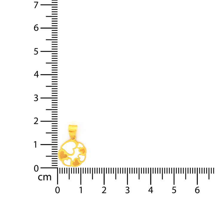 Gold pendant next to a ruler on a white background