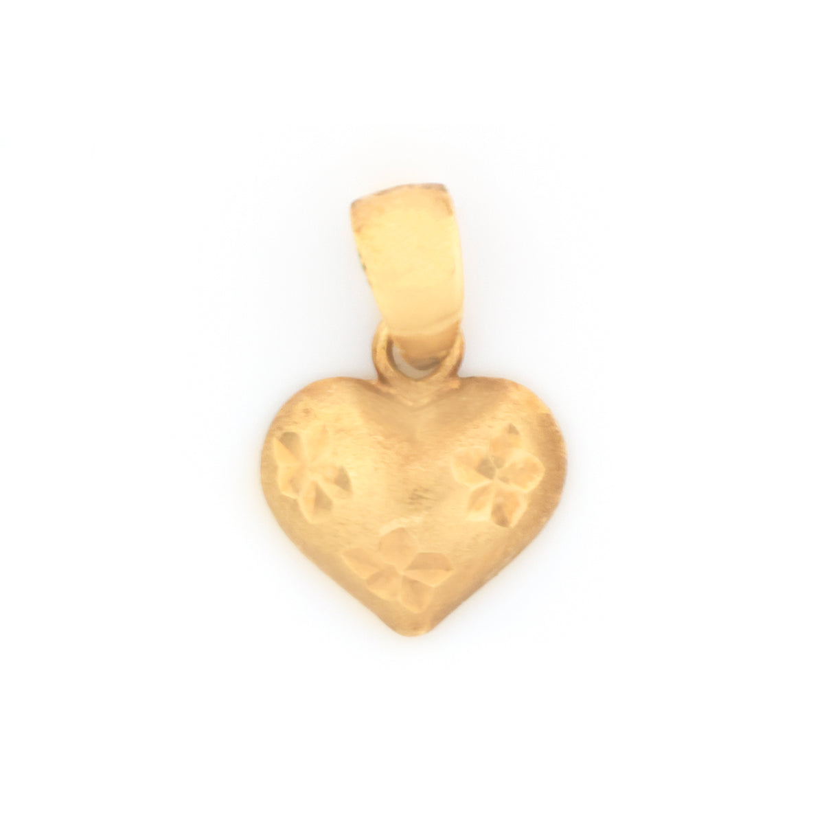 A small gold heart-shaped pendant with a textured surface and floral engravings, shown on a plain white background.