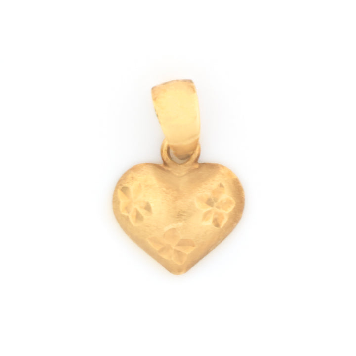 A small gold heart-shaped pendant with a textured surface and floral engravings, shown on a plain white background.