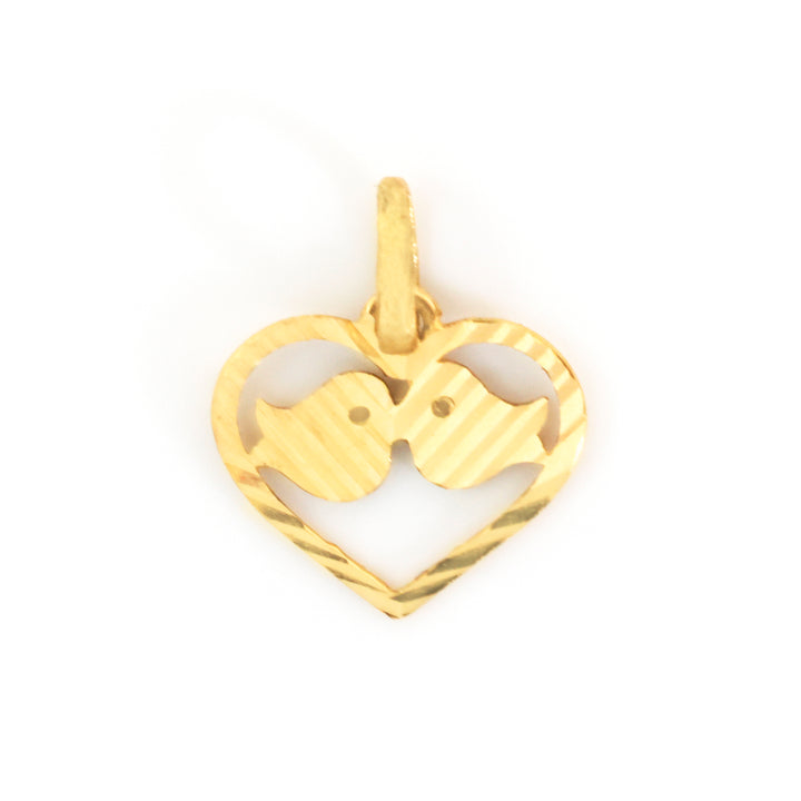 A gold heart-shaped pendant featuring two kissing birds, with one bird cut out to show the other inside, on a plain white background.