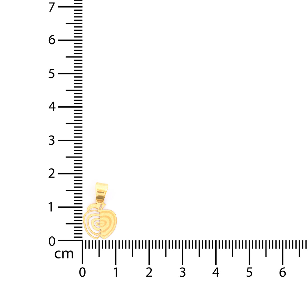Gold pendant next to a ruler on a white background