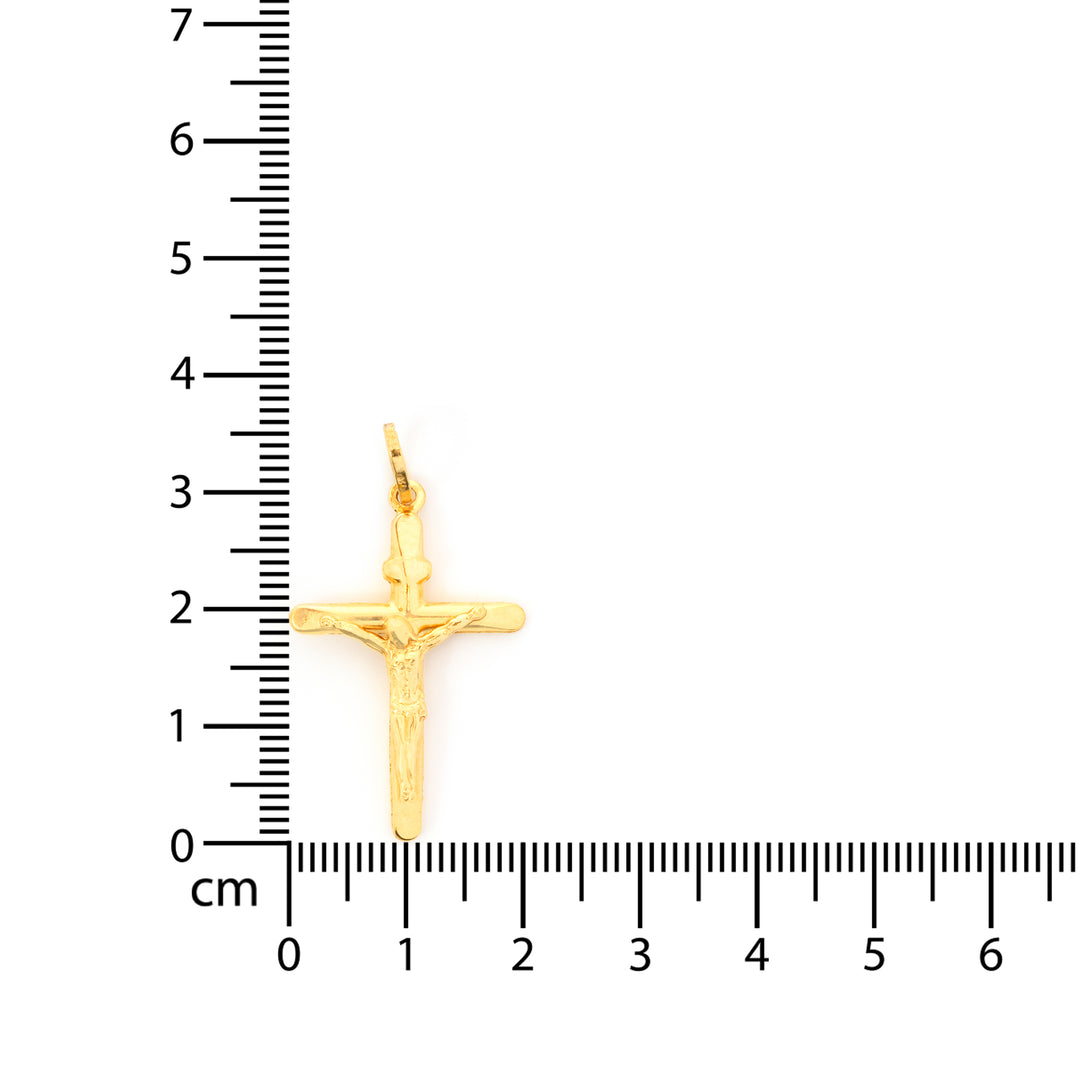 Gold cross pendant with measurement scale on a white background