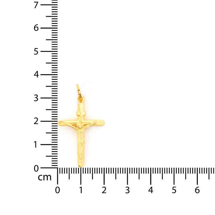 Gold cross pendant with measurement scale on a white background