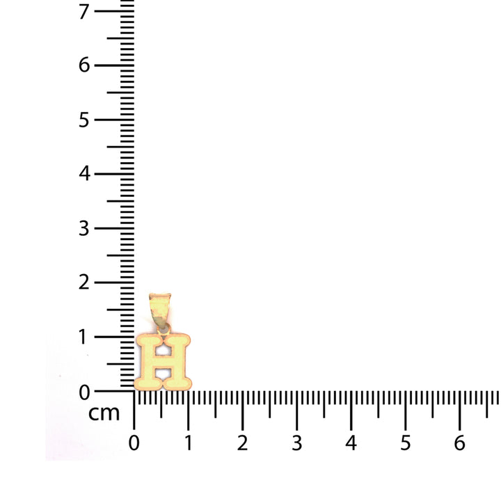 A small gold pendant shaped like the Hebrew letter Shin, displayed next to a centimeter ruler to show its size.