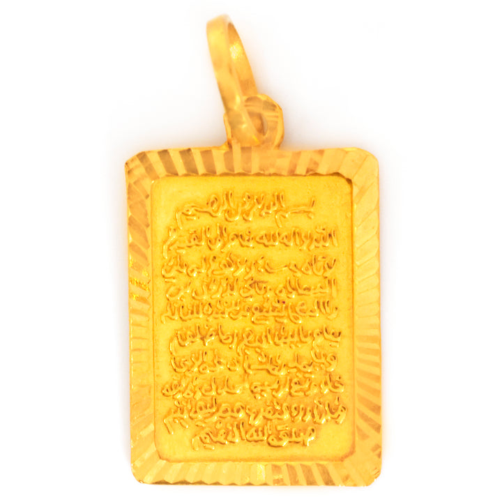 Gold pendant with engraved design on a white background