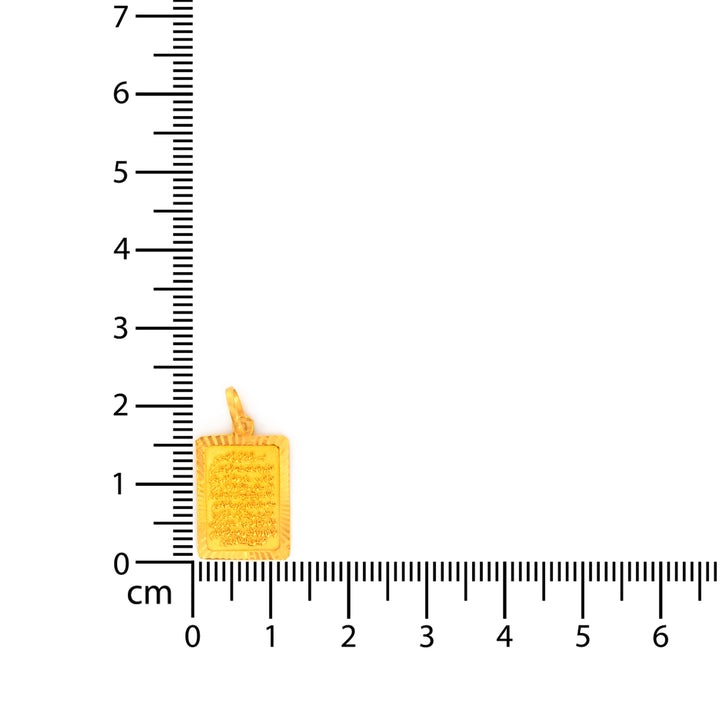 Small yellow candle charm next to a ruler for scale on a white background