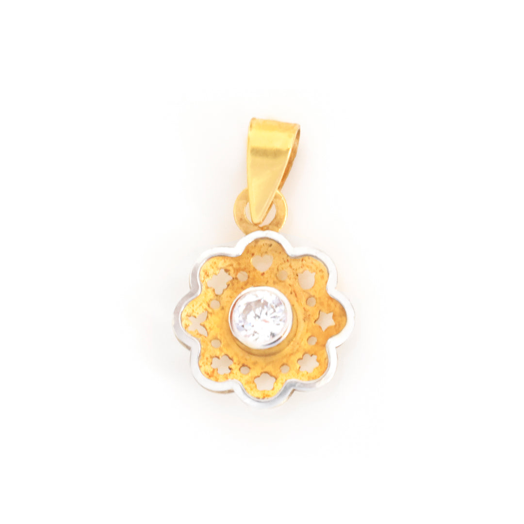 A gold and silver flower-shaped pendant with a single clear round-cut gemstone in the center, shown on a plain white background.