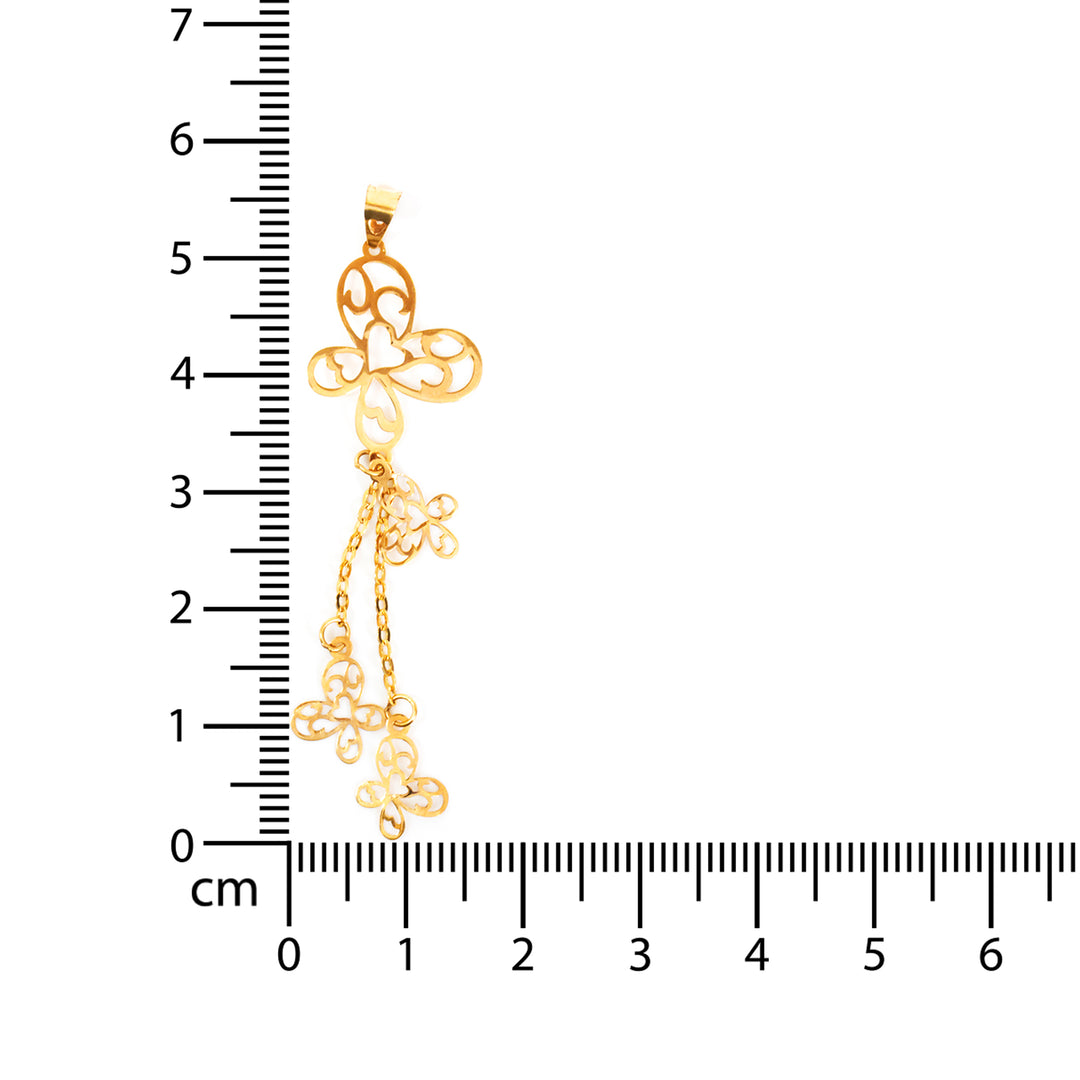Gold rosary with a cross pendant next to a ruler for measurement on a white background
