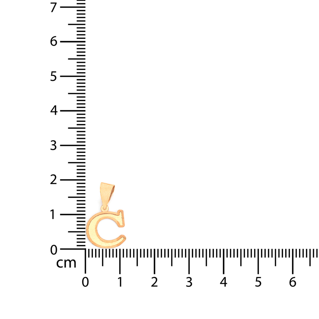 A small gold letter C pendant shown next to a centimeter ruler for scale on a plain white background.