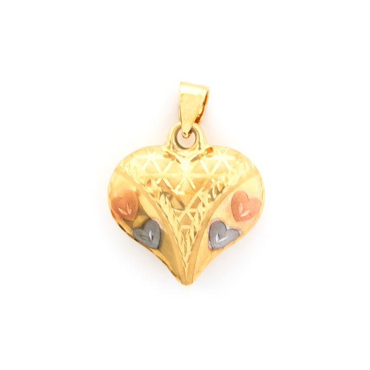 Gold heart-shaped pendant with intricate design on a white background