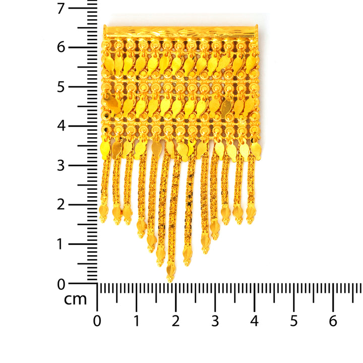 Gold fringe fabric trim with a ruler for scale on a white background