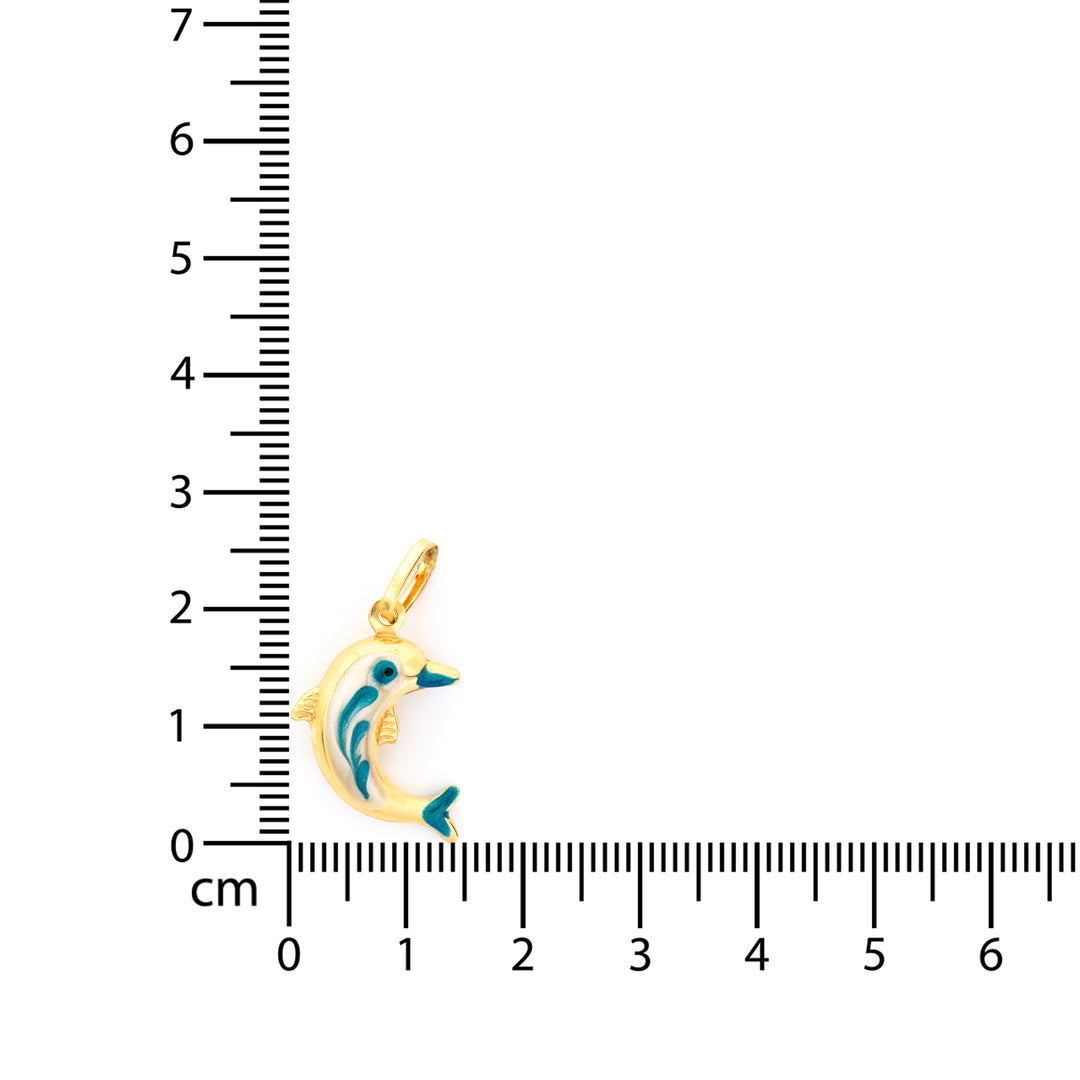 Gold dolphin pendant next to a ruler on a white background