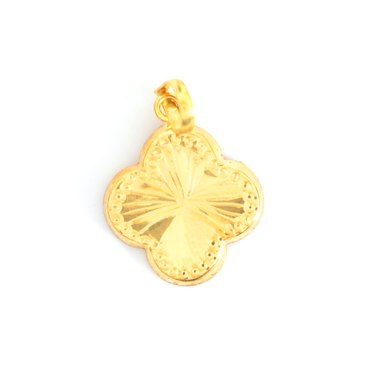 A gold four-leaf clover pendant charm with a textured center and a decorative beaded border, shown on a plain white background.
