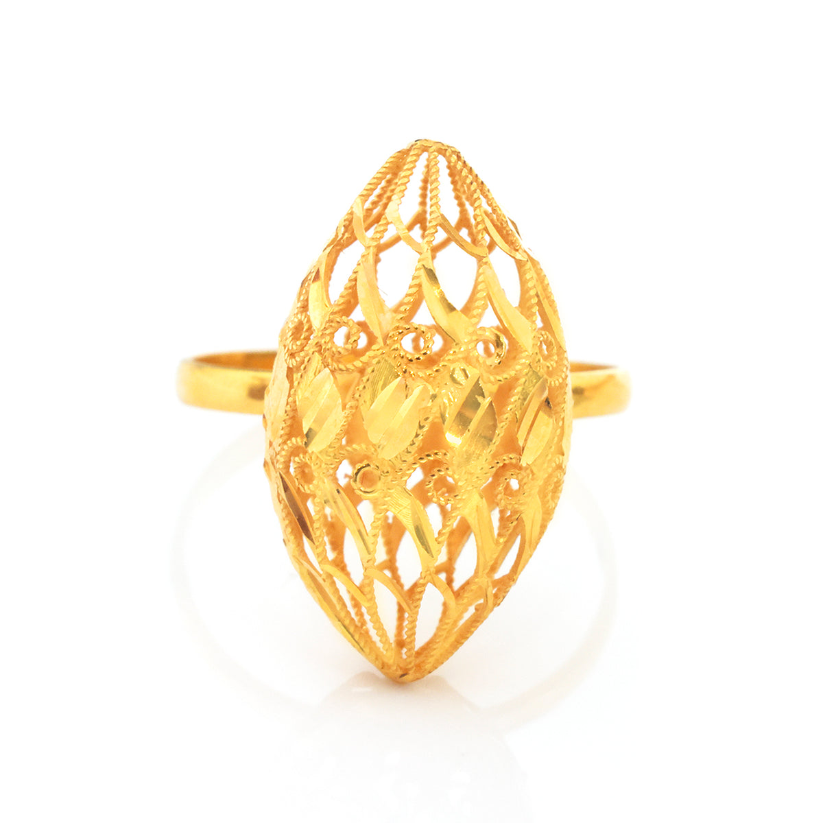 A gold filigree ring with an elongated marquise-shaped openwork design, shown on a clean white background with a soft reflection.