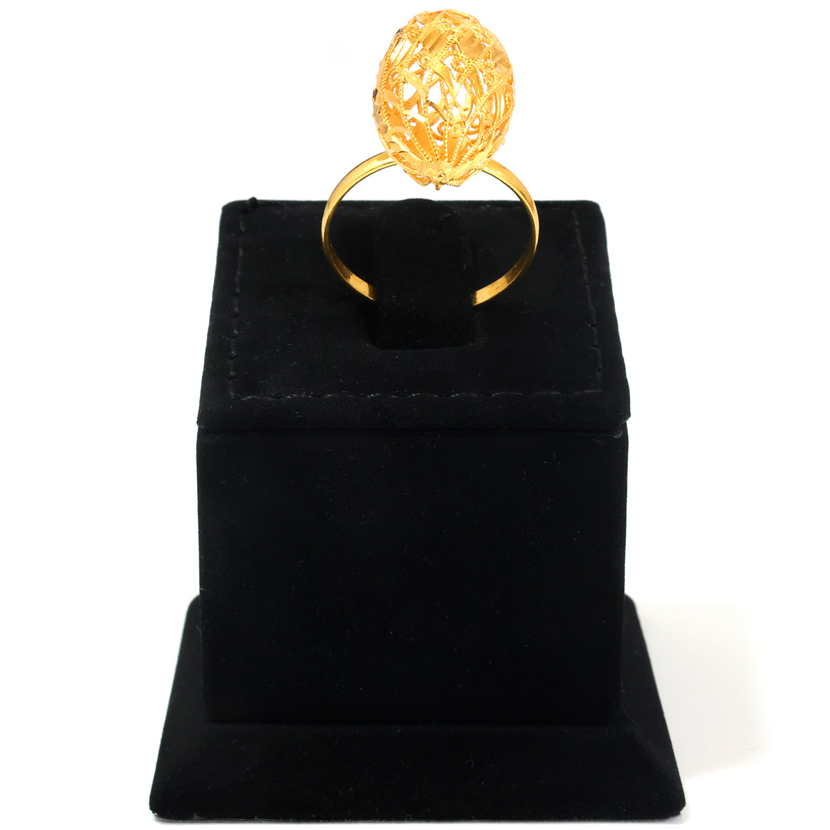 A gold ring with a textured, faceted egg-shaped top, displayed on a black velvet ring box against a white background.