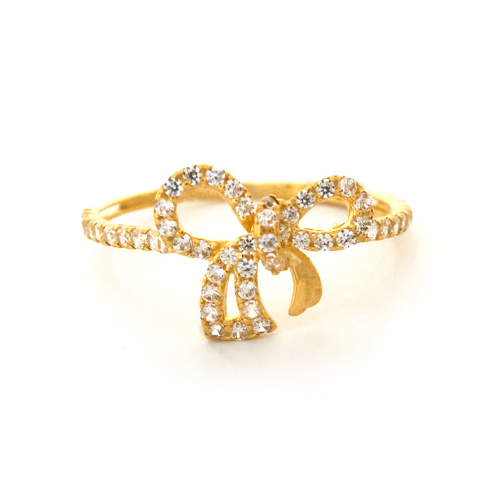 Gold ring with diamond accents on a white background