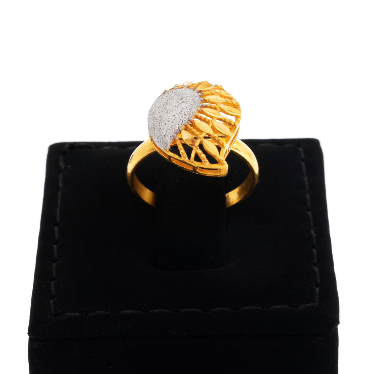 Gold ring with a textured design on a black velvet stand