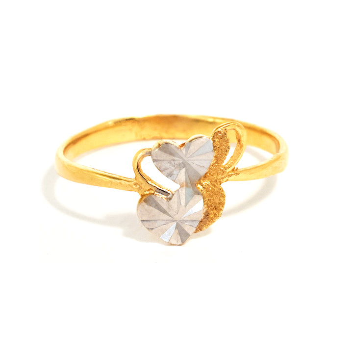 Gold ring with a heart-shaped crystal on a white background