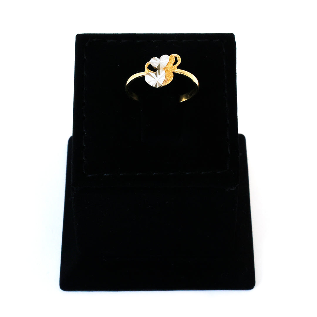 Gold ring with a heart design on a black velvet stand