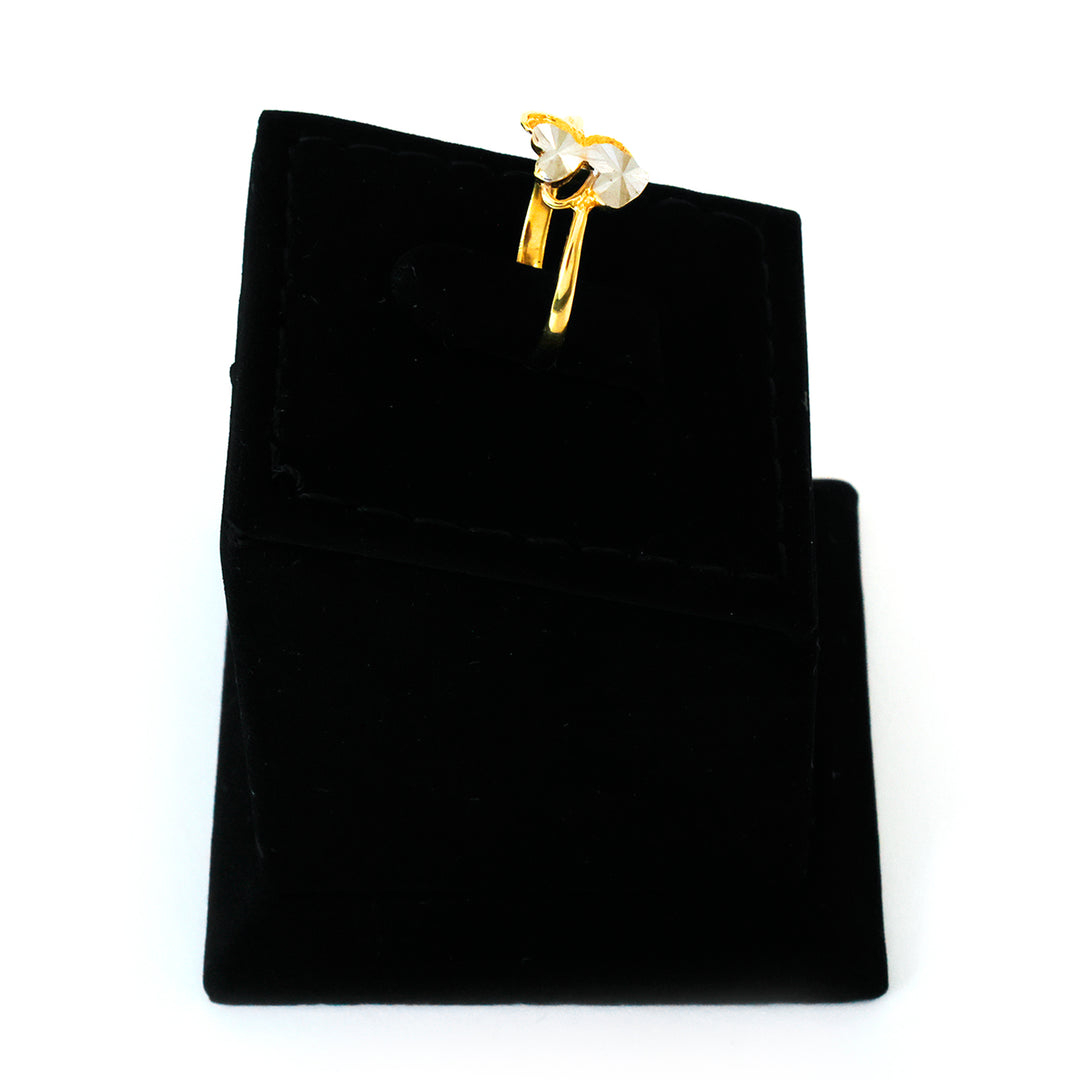 Gold and pearl earring on a black velvet jewelry pouch