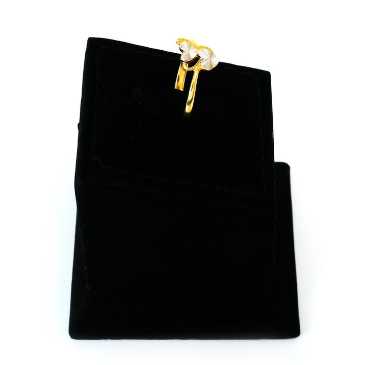 Gold and pearl earring on a black velvet jewelry pouch
