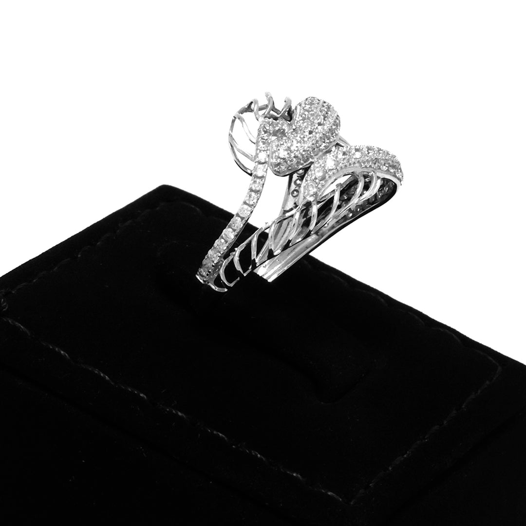 Silver ring with heart design on a black velvet stand