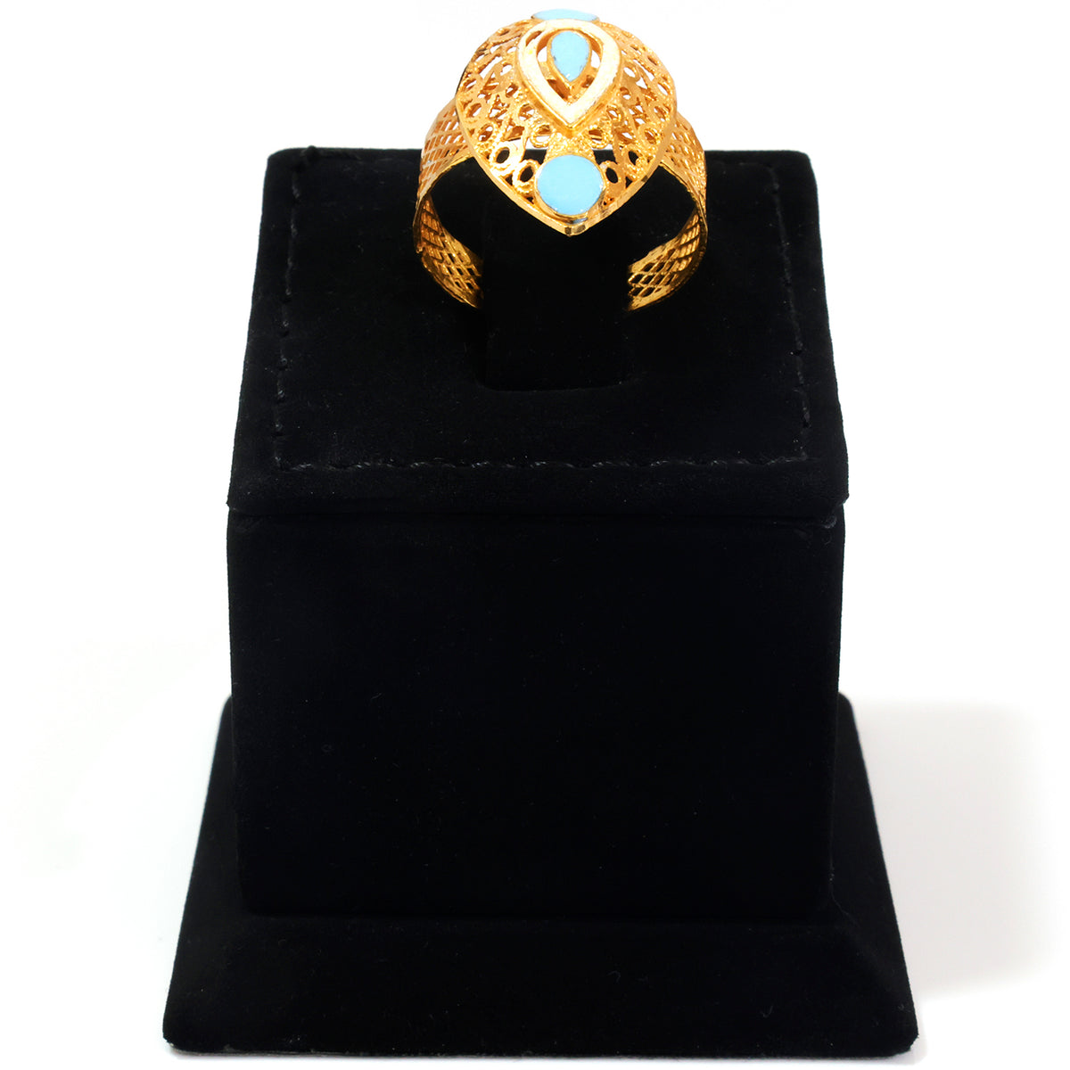 A gold filigree ring with two light blue oval stones, displayed on a black velvet jewelry stand against a white background.