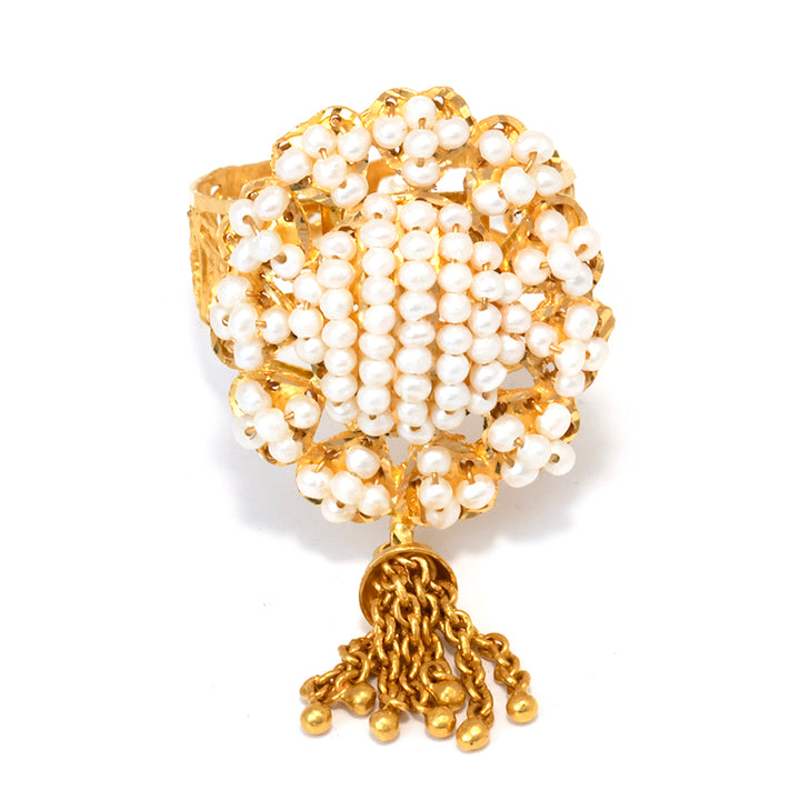 Gold and pearl bracelet on a white background