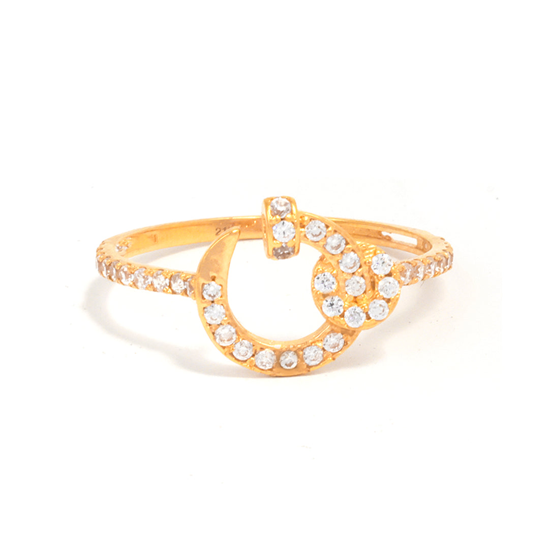 Gold ring with a horseshoe design and clear stones on a white background