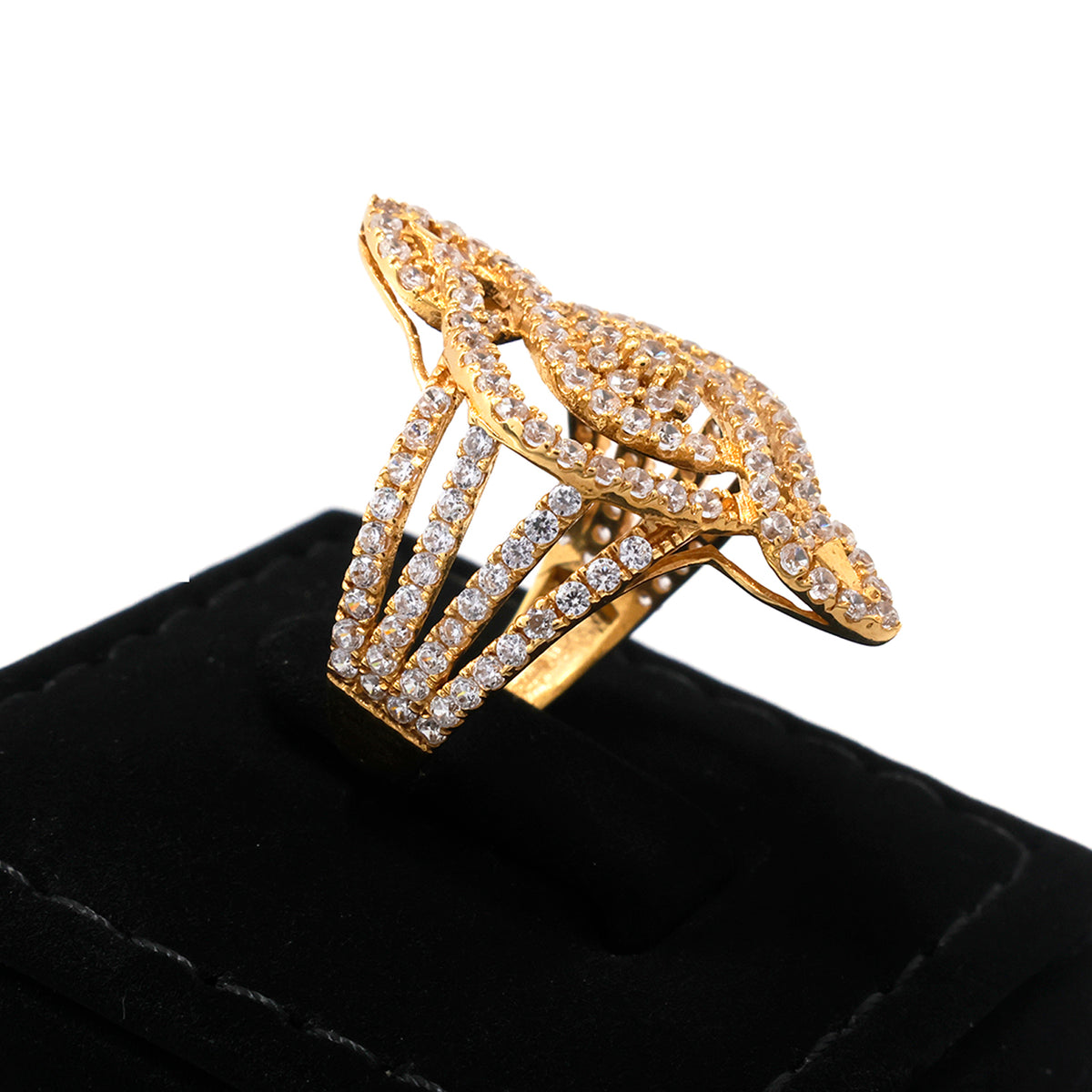Gold ring with diamond accents on a black cushion against a white background