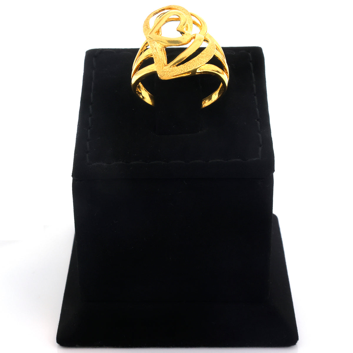 A gold ring with an abstract, sculptural openwork design displayed on a black velvet ring box against a white background.