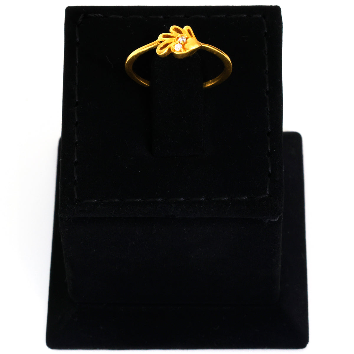 Gold ring with a diamond on a black velvet stand