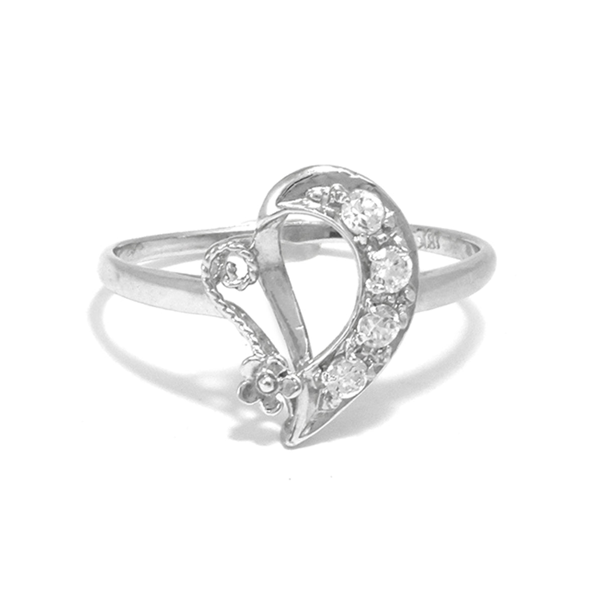 Silver heart-shaped ring with embedded stones on a white background