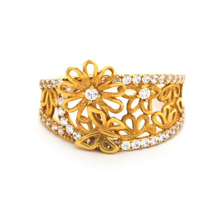 Gold bracelet with floral design and clear stones on a white background