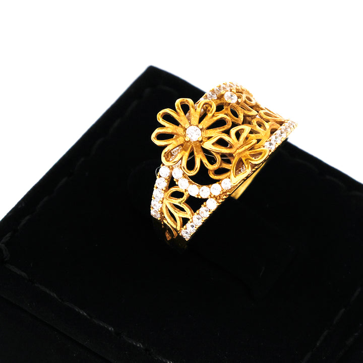 Gold bracelet with floral design on a black velvet surface