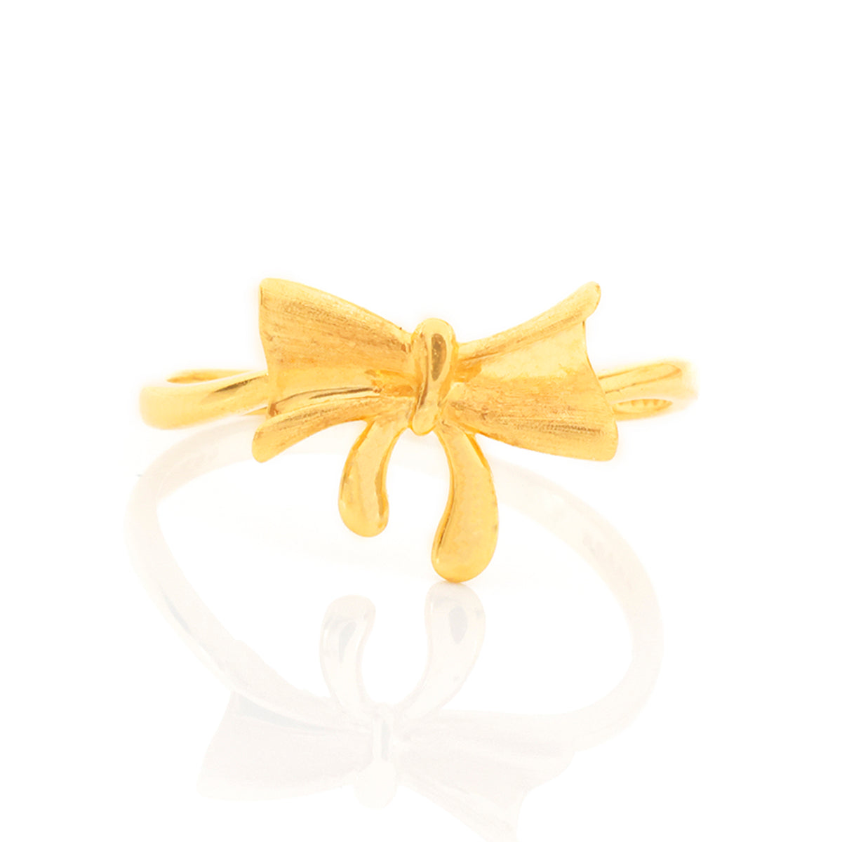 Gold bow-shaped ring on a white background