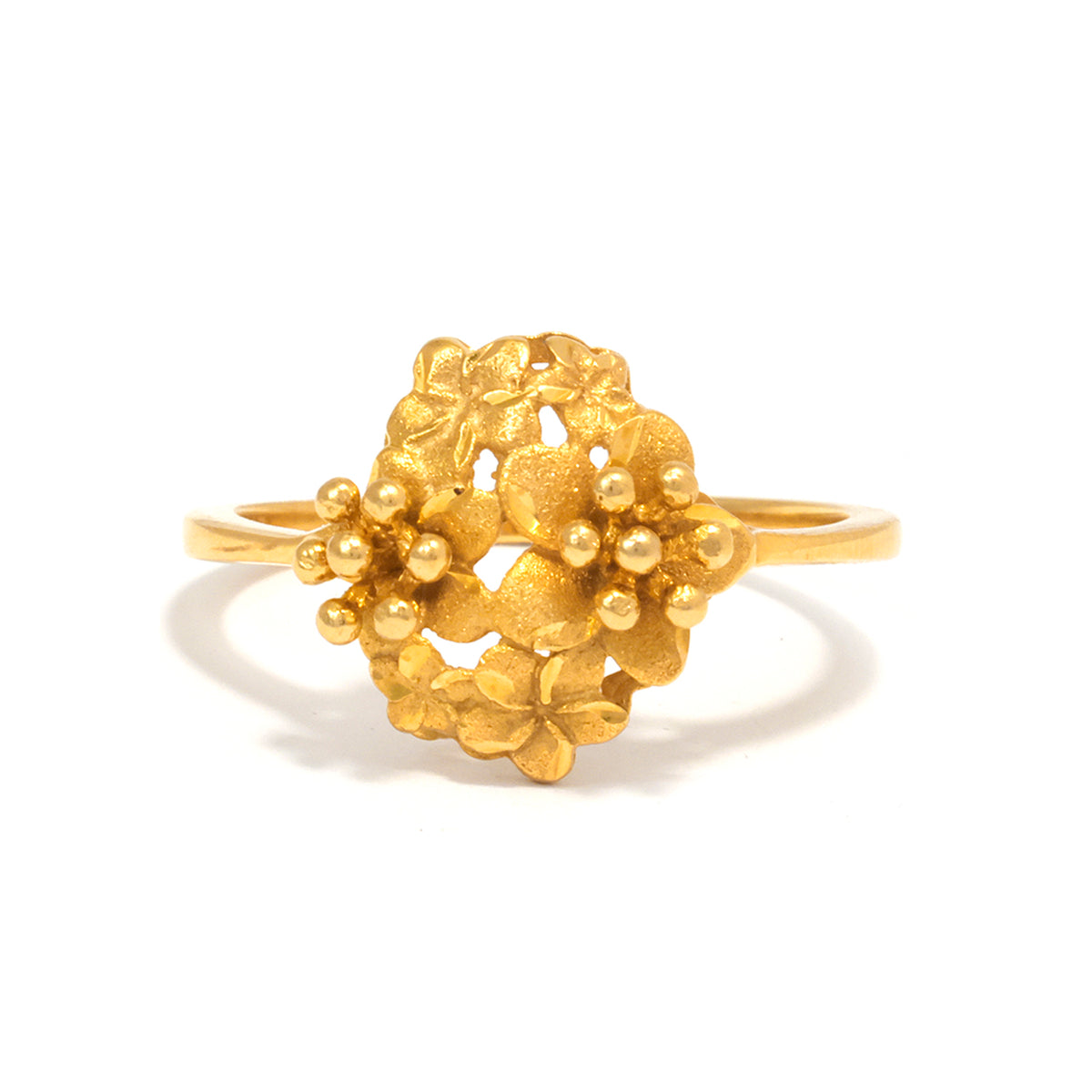 Gold floral ring on a white background