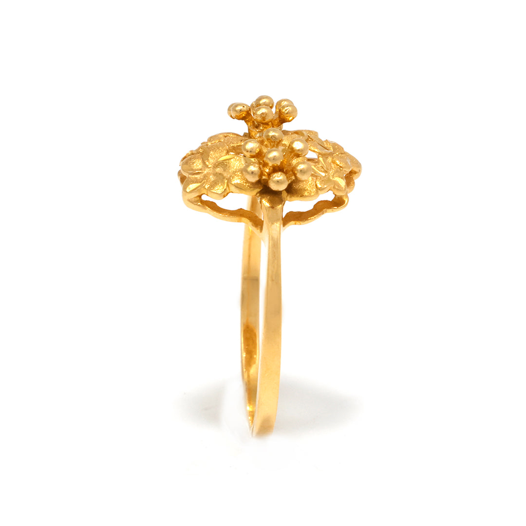 Gold ring with floral design on a white background