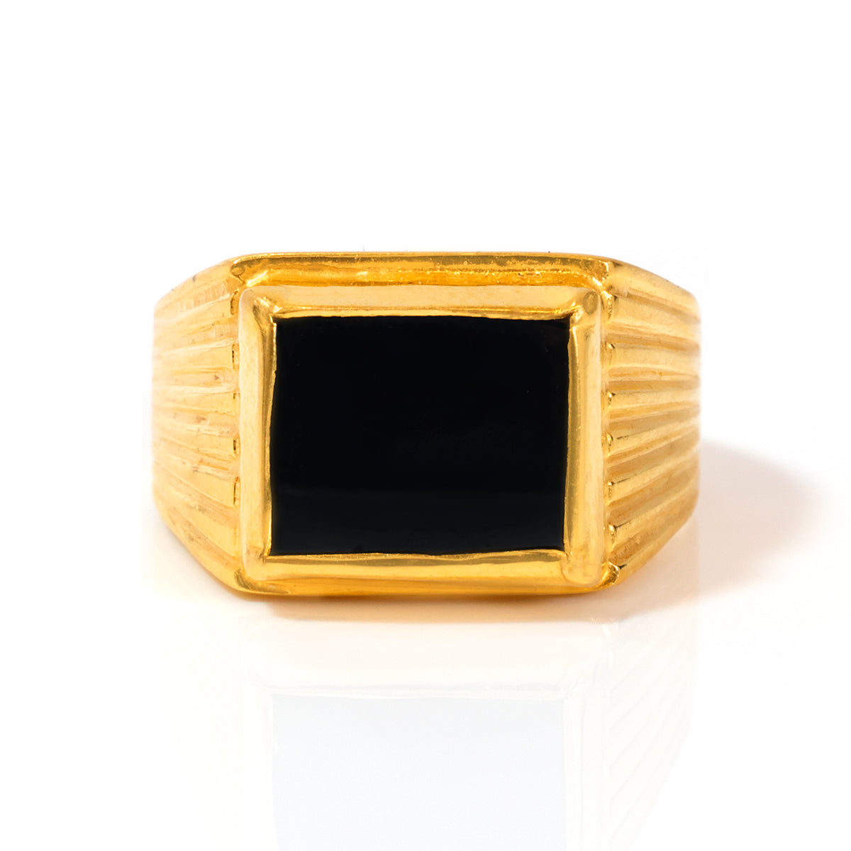 Gold ring with a black square stone on a white background