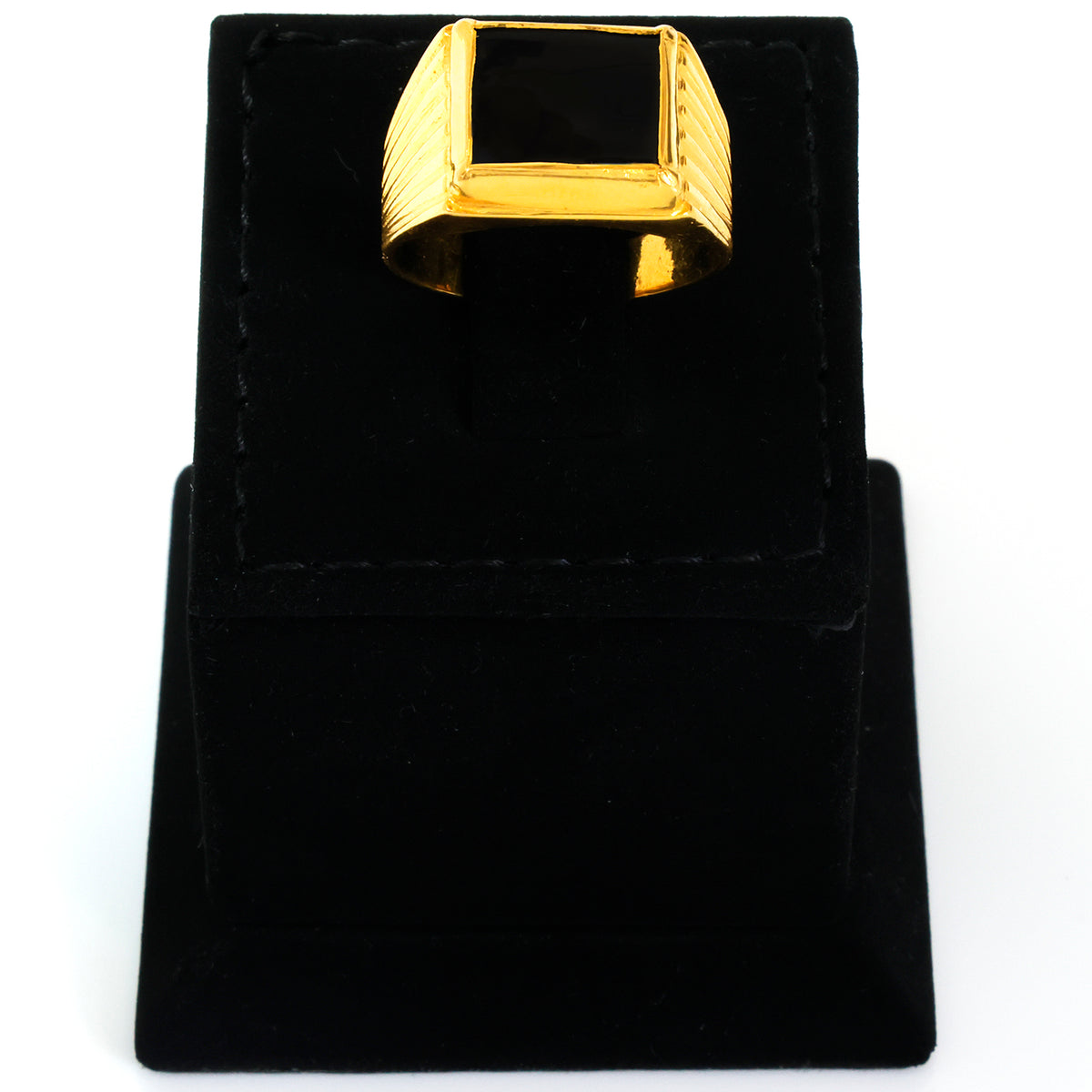 Gold ring on a black velvet stand with a white background