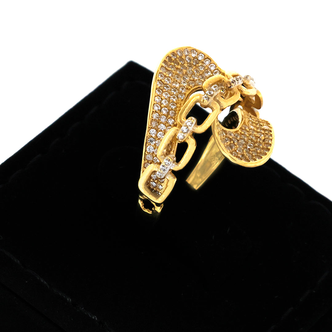 Gold letter 'P' brooch with diamonds on a black background