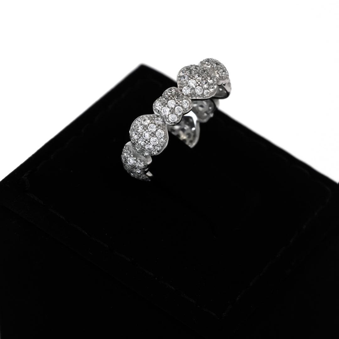 Silver ring with gemstones on a black velvet surface