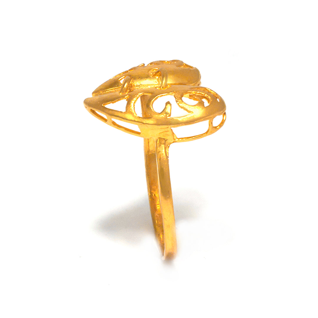 Gold ring with intricate design on a white background