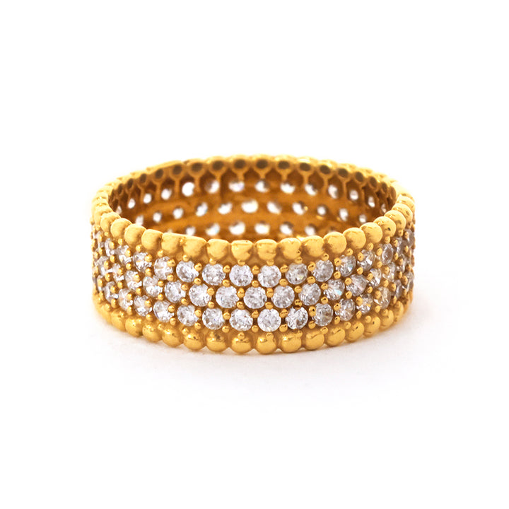 Gold ring with diamond accents on a white background