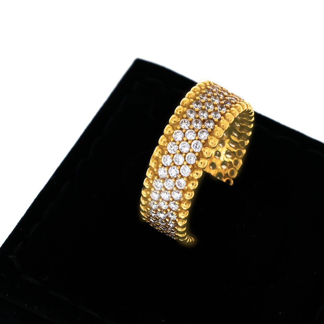 Gold bracelet with clear stones on a black cushion