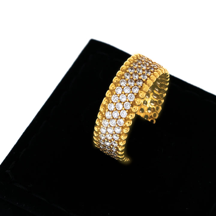 Gold bracelet with clear stones on a black cushion